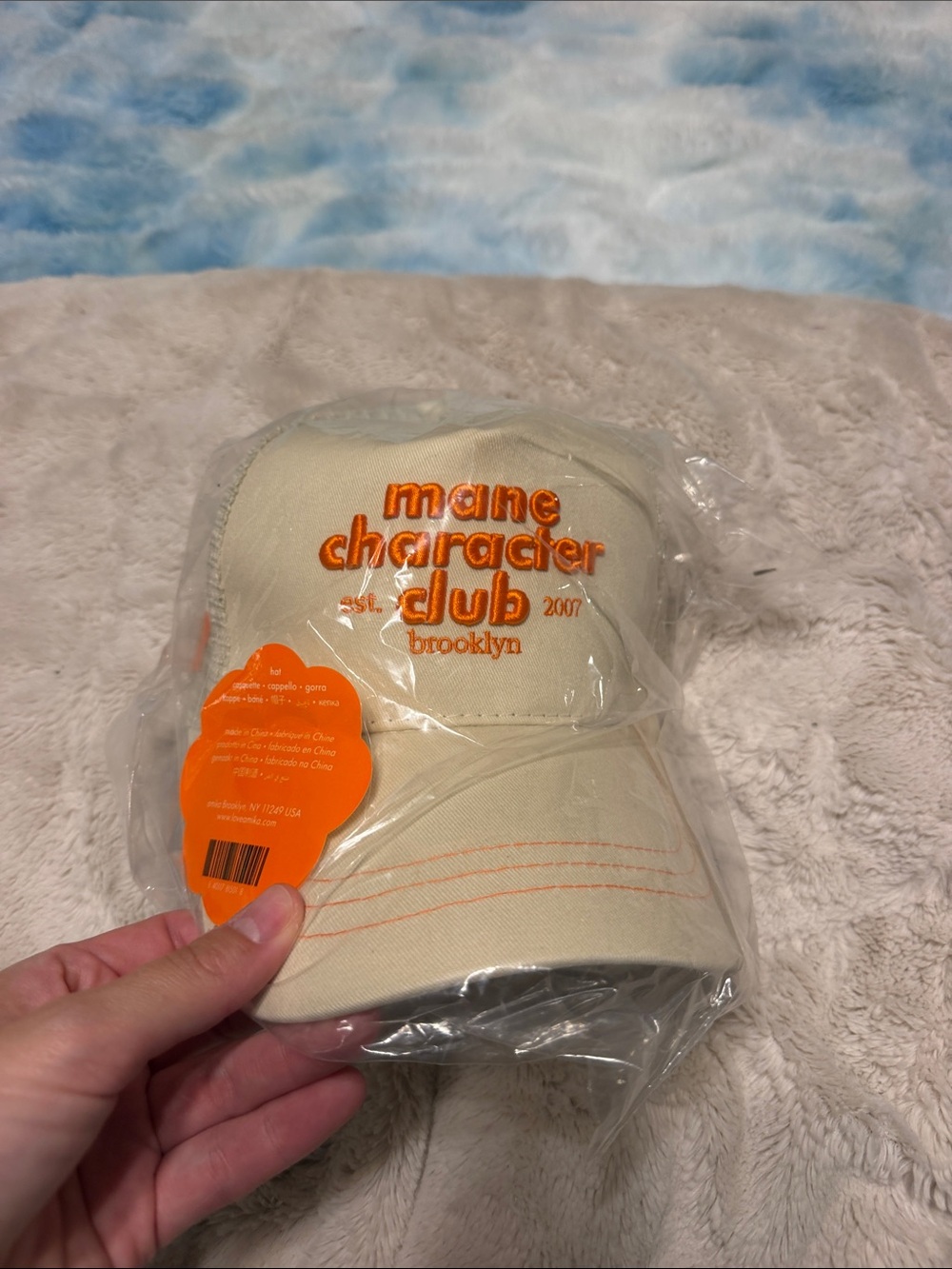 Amika Mane Character Club Women's Beige Trucker Cap with Orange Embroidery